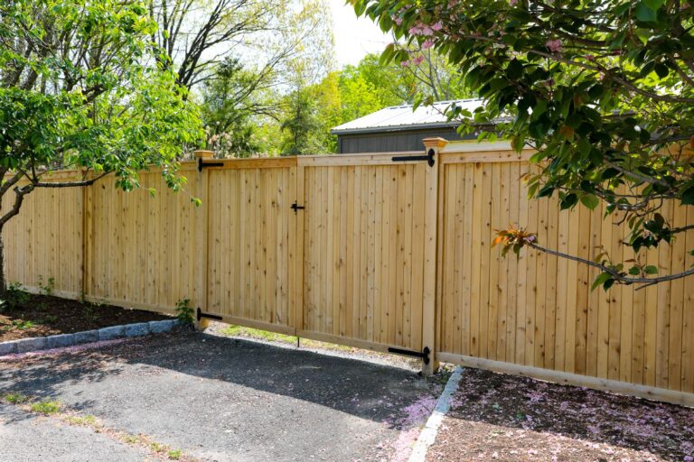 A walk gate leads through this tall wooden privacy fence.